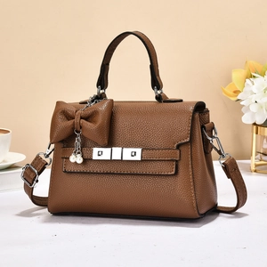 Elegant brown pebbled leather handbag for women with top handle and pearl bow charm detail