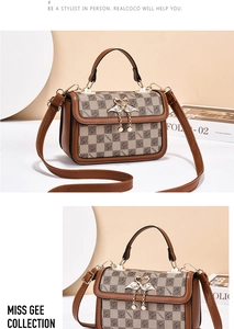 Detail of checkered shoulder bag with golden swan buckle and pearl pendants