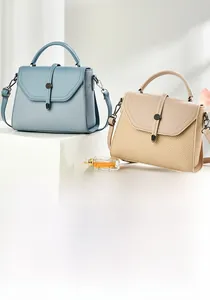 Detail of a chic handbag featuring leather and woven patchwork with a metal buckle