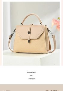 Close-up of beige straw texture and leather flap with metal snap on a shoulder bag