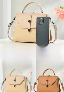 Detailed size comparison of two-tone woven crossbody bag with phone reference