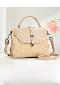 Detailed front view of a beige crossbody bag with woven texture and gold metal buckle