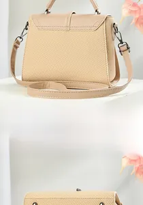 Detail of straw texture and leather splicing on a beige crossbody bag with metal buckle