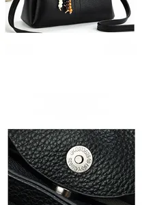 Detail of metal magnetic buckle and lychee grain leather on black shoulder bag