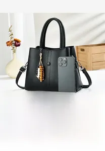 Detail of black pebbled leather tote capacity with smartphone for size reference