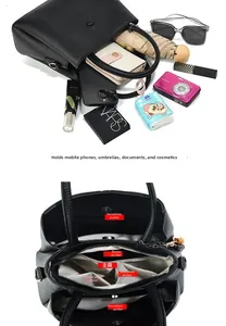 Detail view of large black leather bag showing multi-pocket interior storage capacity