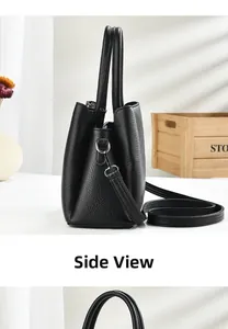 Side view of black pebble leather tote bag with silver hardware and adjustable strap