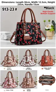 Detail view of cherry print handbag showing multi-layer interior and side charms