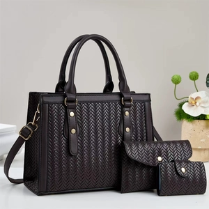 Detailed view of dark brown woven three-piece bag set with gold hardware accents