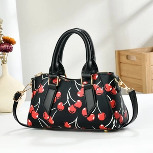 Black cherry print tote bag with adjustable shoulder strap and gold hardware accents