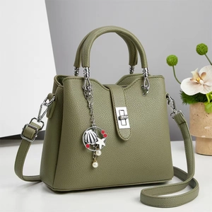 Olive green textured leather handbag with silver twist lock and ocean theme pendant