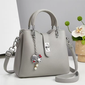 Elegant grey leather trapezoid handbag with marine charm and silver buckle