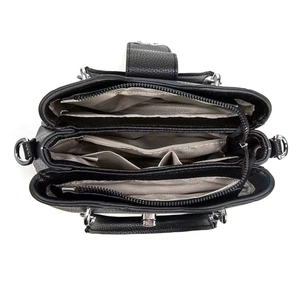 Internal view of black leather handbag featuring three compartments and silver hardware