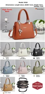 Detail view of stylish litchi grain leather tote bag with elegant shell pendant and hardware