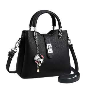 Black lychee leather handbag with silver hardware and nautical shell charm pendant