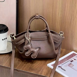 Chic dark coffee lychee pattern handbag with puppy charm and crossbody strap