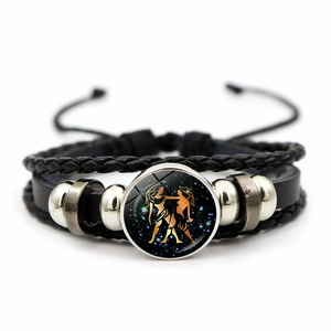 Macro shot of multi-layer leather bracelet with Gemini zodiac star glass charm detail