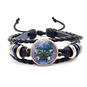Braided leather bracelet with dreamcatcher and dragonfly glass cabochon charm