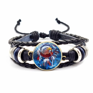 Close-up of multilayer woven leather bracelet with eagle dreamcatcher glass cabochon
