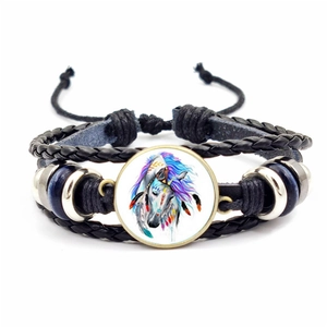 Detailed view of multilayer woven bracelet with unicorn glass gem and adjustable cord