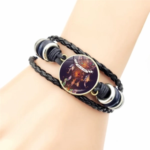 Braided leather dreamcatcher bracelet with blue beads and a wolf totem glass pendant