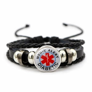 Detail of medical alert diabetic symbol on black braided leather bracelet with beads