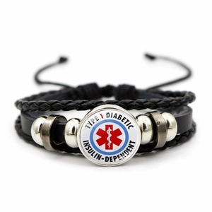 Macro detail of Type 1 Diabetic medical alert symbol on black woven leather bracelet