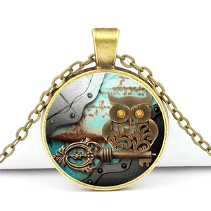 Steampunk owl necklace with antique bronze pendant and vintage clockwork key elements