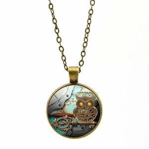 Detailed view of bronze steampunk owl pendant with key on vintage industrial background