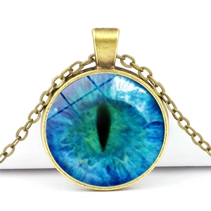 Vintage bronze evil eye pendant necklace with blue glass dome on white background