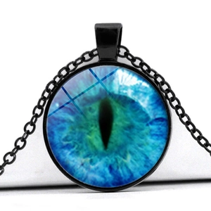 Macro shot of circular blue evil eye glass pendant with black chain and metal frame