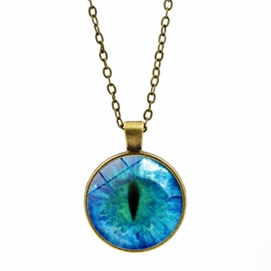 Close-up of vintage bronze necklace with blue evil eye glass gem pendant