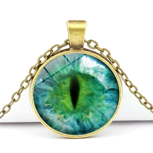 Vintage bronze necklace with a mystical green dragon eye glass cabochon pendant