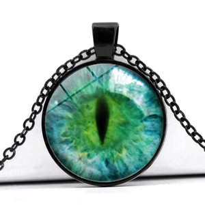 Macro shot of green cat eye glass pendant with black alloy chain for vintage style