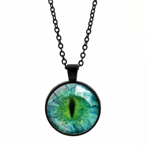 Detail of green cat-eye glass dome pendant necklace with a black metal frame and chain