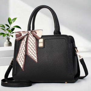 Black litchi grain tote bag with silk scarf decoration and gold buckle on stairs