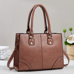 Minimalist tote bag for women in mauve brown leather with golden hardware and strap