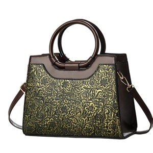 Retro dark brown leather tote bag featuring gold floral embossing and round handle