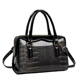 Black patent leather handbag with glittery crocodile texture and gold-tone hardware