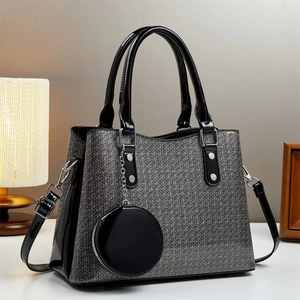 Grey textured handbag with black patent leather trim and a matching coin purse charm
