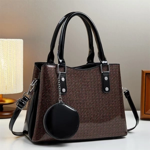 Brown glitter tote bag with black patent handles, crossbody strap and circular charm