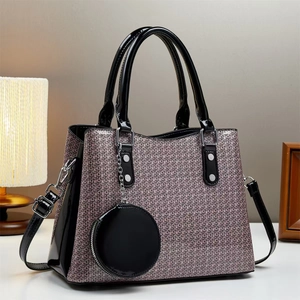 Detail of woven texture tote bag in purple and grey with black patent leather accents