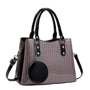 Fashionable purple woven tote bag with black leather straps and round coin pouch charm