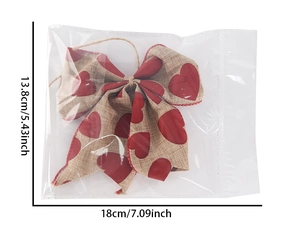 Macro shot of linen bow with red heart print packaged for Valentine party decor
