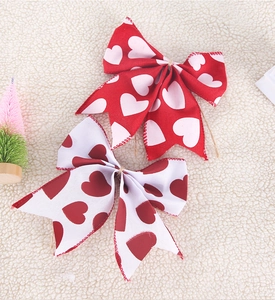 Macro shot of handmade heart print linen bows with rustic rope ties for gift wrapping