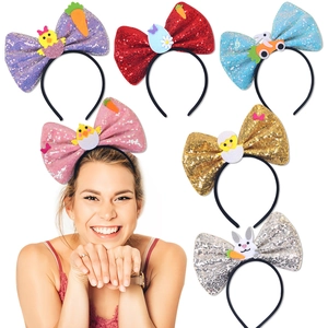 Detail of Easter glitter bow headbands with cartoon chick, egg, and rabbit decorations
