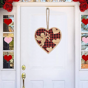 Valentine wooden heart decoration with red plaid fabric and cupid cutouts on white door