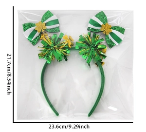 Detail view of St. Patrick's Day green headband with sequin bows and shamrock charms