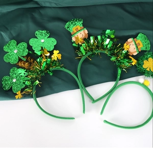 Detail of St. Patrick's Day headbands with green glitter shamrocks and tinsel fringe