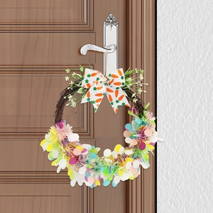 Easter wreath with natural vine base colorful tinsel and white carrot pattern bow on wooden door